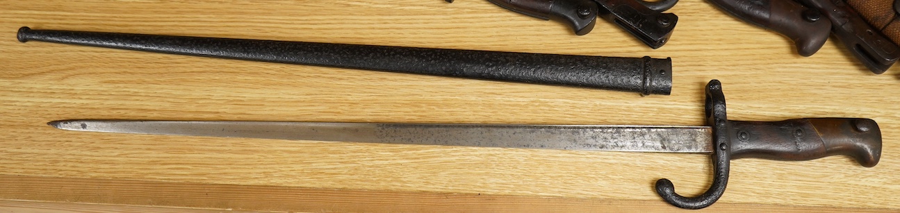 Six assorted bayonets; a 1907 pattern in its scabbard, a 1903 Wilkinson bayonet (no scabbard), two Gras bayonets (one in scabbard), a German Mauser bayonet, and a Remington First World War bayonet. Condition - poor to fa